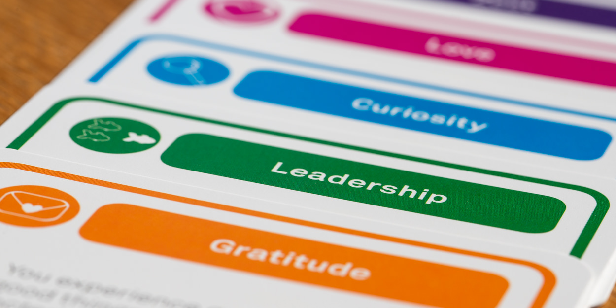 Close up of VIA strengths cards - showing Gratitude, Leadership, Curiosity, Love